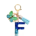 Detail of glitter resin letter F keychain with butterfly charm and light blue tassel - Letter F