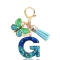 Detail of teal sequin resin letter G keychain with butterfly pendant and blue tassel - Letter G