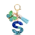 Detail of blue sequin resin letter S keychain with butterfly charm and blue suede tassel - Letter S