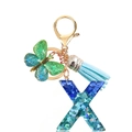 Detail of blue sequin letter X keychain with butterfly charm and light blue suede tassel - Letter X