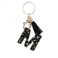 Letter M keychain with black resin, colorful star sequins, and a black stylish tassel - Letter M