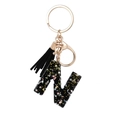 Black resin letter N keychain with gold glitter, star sequins and black tassel - Letter N