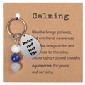Detail of natural stone keychain with engraved Relax and feel life drop pendant - Inner Peace