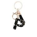 Chic black resin letter P keychain with gold stars and black silk tassel decoration - Letter P