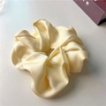 Pale yellow satin scrunchie with silk-like texture and soft pleats for elegant ponytail - Off White