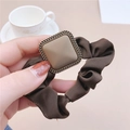 Close-up of vintage brown scrunchie with a gold square buckle and textured fabric - Brown