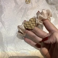 Close-up of champagne satin scrunchie with khaki woven heart detail in hand - Milk Tea (A-3286-1)