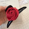 Detail of large black hair claw clip featuring a realistic red fabric rose decoration - Large Rose Red (D-4110-1)