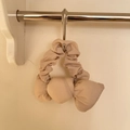 Detailed view of beige cotton bow scrunchie with soft pleated texture on metal hook - Champagne
