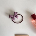 Detail of purple glossy bow hair tie with dark brown elastic band and perfume bottle accessory - Purple Bow (D-4013-7)