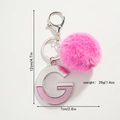 Porte-clés pompon rose avec lettre G en métal montrant les dimensions hauteur 12cm et largeur 7cm - Lettre G