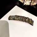 Glinsterende haarclip met kristallen in donkergouden afwerking op witte kaart - Zilverzwart Strass (B-1352)