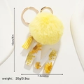 Detailed view of yellow faux fur pompom and resin letter M keychain with dried flowers - Letter M Style (M)