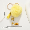 Detail of yellow daisy keychain with faux fur pompom, tassel, and resin letter L charm - Letter L Style (L)