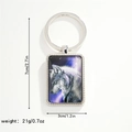 Detail view of rectangular wolf charm keychain with purple galaxy background and silver ring - Purple Starry Wolf Keychain (Style 2)