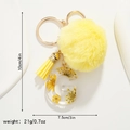 Detail of yellow resin letter G keychain with faux fur pompom and tassel charm - Letter G Style (G)