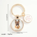 Detail of golden German Shepherd dog pendant with paw print charm for bags and keys - German Shepherd (I AM BATMAN)