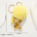 Detail of yellow daisy keychain with resin letter K, fuzzy pompom and measurements - Letter K Style (K)