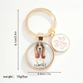 Detail view of dog pendant keychain with I CAN FLY text and pink paw print charm - Basset Hound (I CAN FLY)