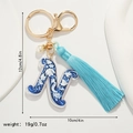Detailed view of Letter N keychain with blue floral patterns and soft tassel fringe - Letter N