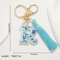 Detail of letter R keychain with blue porcelain pattern, silk tassel and measurements - Letter R