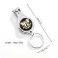 Macro detail of multi-function keychain nail clipper with letter H floral design - Letter H