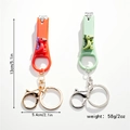 Cartoon 3D siliconen dinosaurus nagelknipper sleutelhanger met opener in oranje en groen - Dinosauriër Stijl (Set van 2)