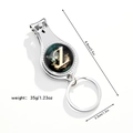 Close-up of multifunctional keychain nail clipper with butterfly and gold letter L - Letter Z