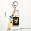 Golden letter S keychain with colorful butterfly charm and yellow tassel decoration - S