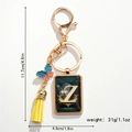 Detail of golden keychain with letter Z pendant, yellow tassel, and colorful butterfly - Letter Z