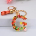 Porte-clés lettre G en résine avec tranches de fruits, métal doré et pompon orange - Lettre G