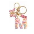 Detail of glitter resin letter M keychain with pink butterfly and tassel accessories - Letter M