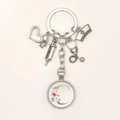 Detail of medical keychain with silver charms, nurse hat, syringe and floral letter C - Letter C / 9.5CM