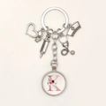 Detail view of silver medical keychain with syringe, stethoscope and floral letter K charms - Letter K / 9.5CM