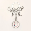 Detail of medical theme keychain with syringe charms and a floral letter U pendant - Letter U / 9.5CM
