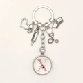 Detailed nurse keychain with stethoscope, syringe, and floral letter X charm on white background - Letter X / 9.5CM