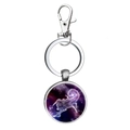 Macro shot of Scorpio constellation keychain pendant with glowing purple star galaxy theme - Scorpio
