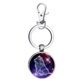 Macro detail of Leo zodiac sign keychain with celestial galaxy pattern in a round pendant - Leo