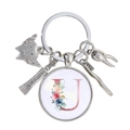 Détail d'un porte-clés dentaire avec dent en argent, brosse à dents et lettre U fleurie - Motif Alphabet U (U)