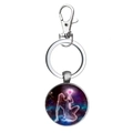 Macro view of the Virgo zodiac sign glass dome pendant on a silver metal keychain - Virgo