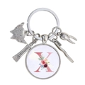 Détail de porte-clés dentiste avec breloques dent, dentifrice et pendentif fleur lettre X - Motif Alphabet X (X)