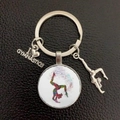 Detailed shot of gymnast silhouette pendant and heart charm on a silver keychain - Handstand Silhouette (11)