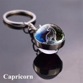Close-up of a double-sided glass orb keychain featuring the Capricorn constellation - Capricorn (4)
