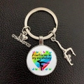 Close-up of gymnastics keychain with I Love Gymnastics charms on black leather texture - Butterfly Heart (6)