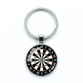 Macro detail of dartboard keychain featuring round glass dome and metal clasp - High Contrast Pattern (6)