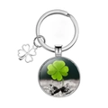 Detailed view of silver four-leaf clover keychain with convex glass dome and metal ring - Realistic Green Leaf Style (1)