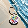 Close-up of Bingo game keychain with colorful billiard ball charms on natural rock background - Bingo Letter And Number Balls Pattern(5)