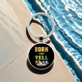Close-up of metal keychain with Born to Yell Bingo text over blue water background - Born To Yell Bingo(8)