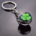 Macro shot of glass ball keychain featuring a four-leaf clover charm with reflection - Shamrock Dark Texture(12)