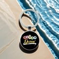 Detail view of Bingo Queen keychain with colorful balls on a textured stone by water - Bingo Queen (12)
